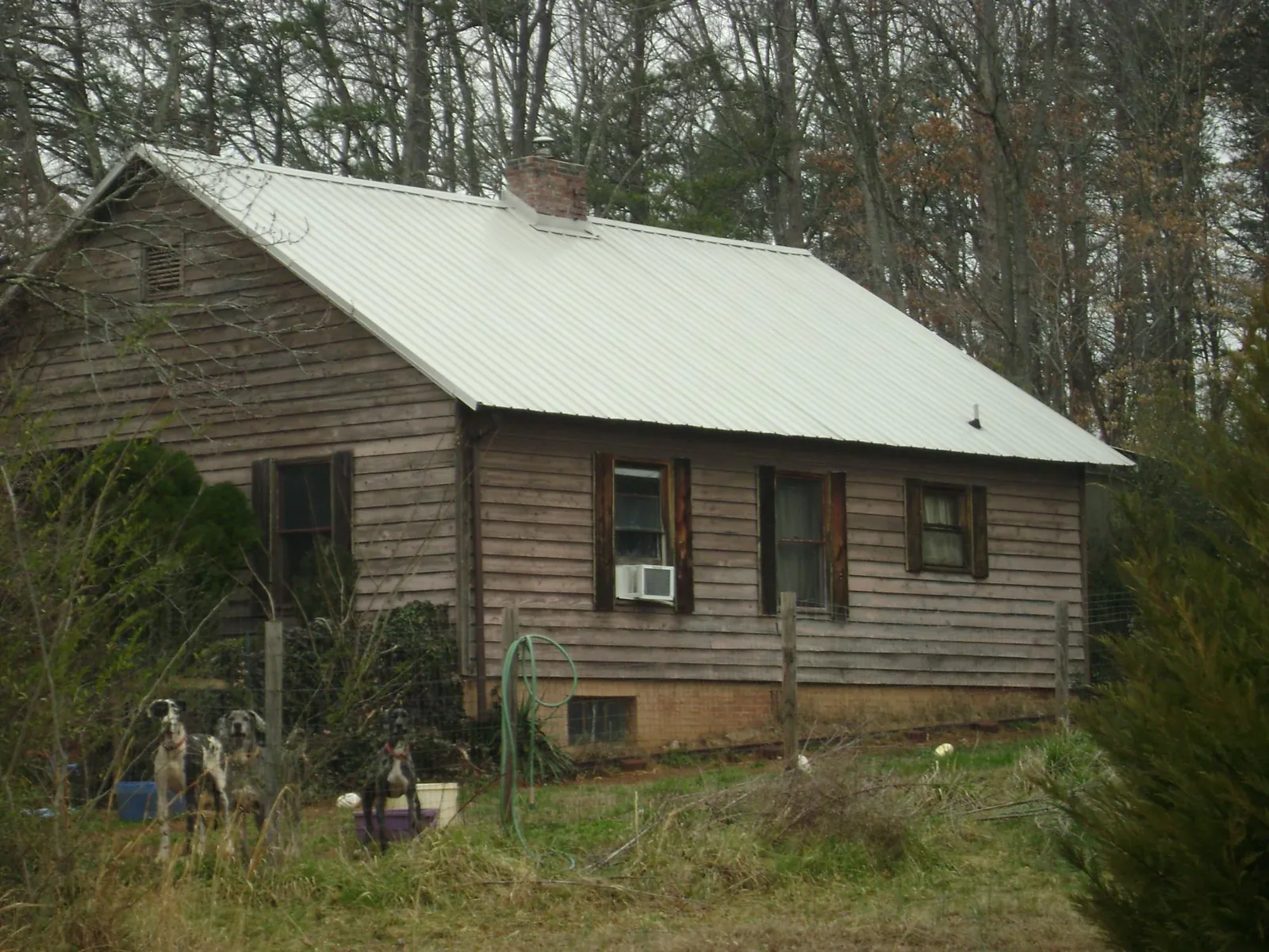 White metal roof on an old wood sided farmhouse, from a Metal Roof Installation job in Hamburg